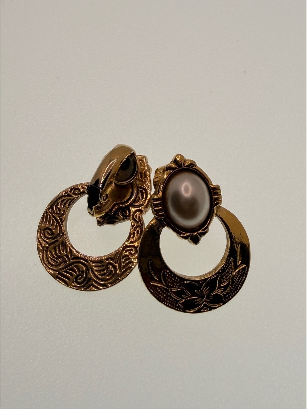 Gold tone hoop clip earrings with faux pearl